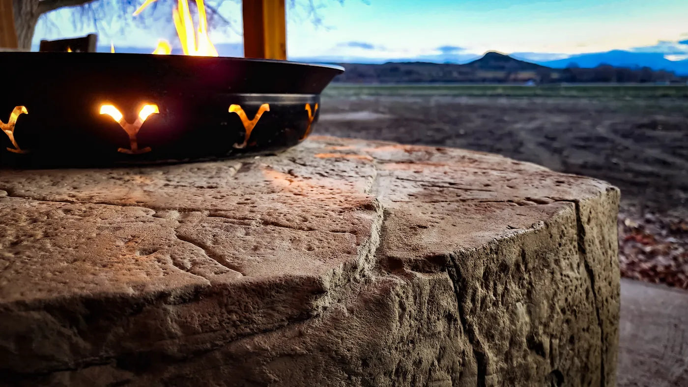 Carved boulder fire pit surround at sunset