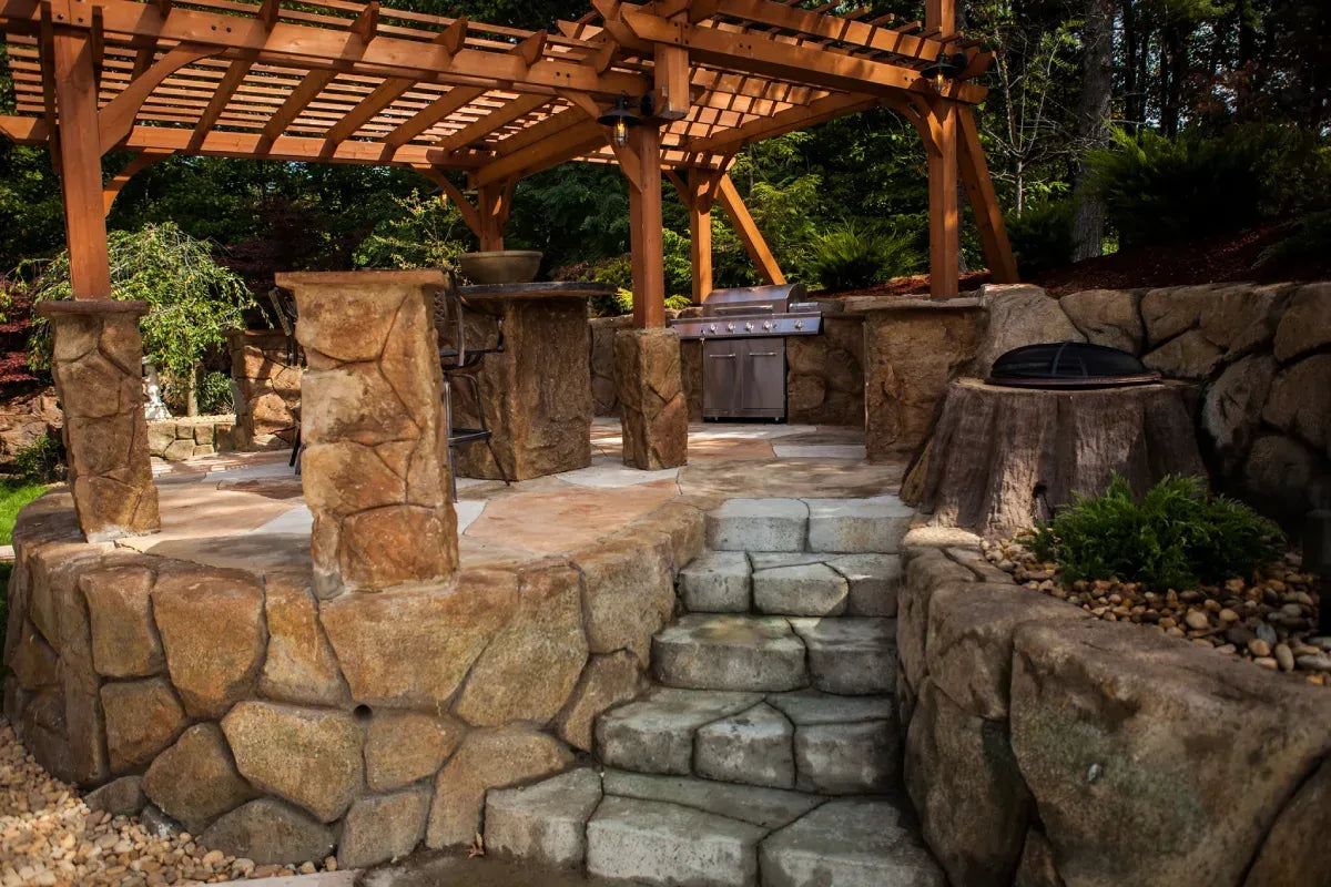 Outdoor kitchen with carved stone columns and walls