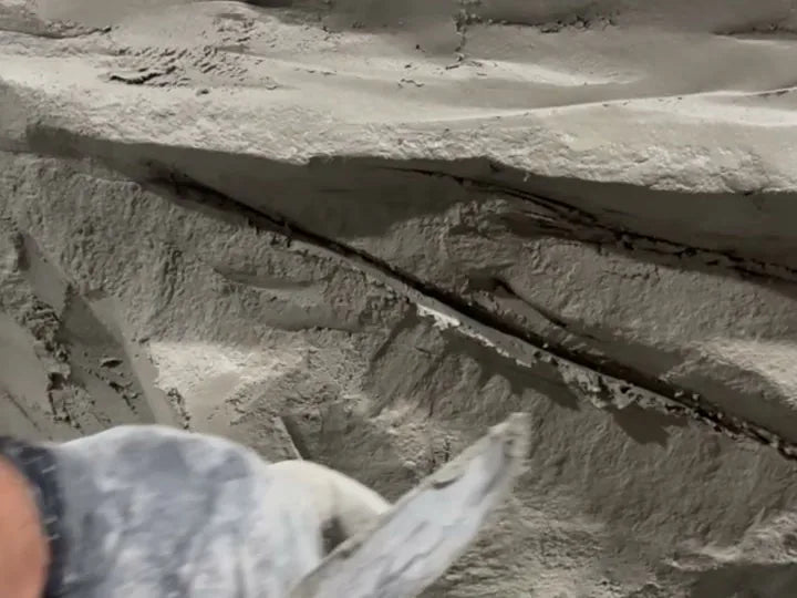 Trowel cutting ledges into fresh concrete