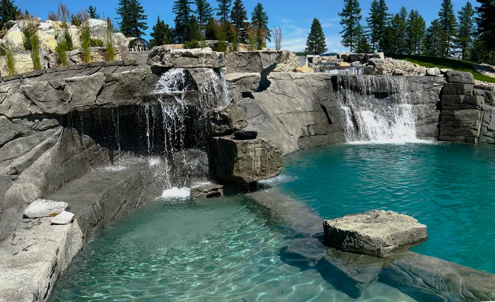 Carved rock waterfall spilling into a pool
